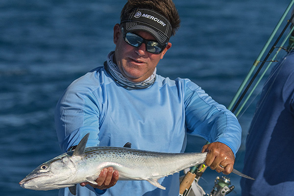 Captain Rich Tudor, co-host of Saltwater Experience holds a catch on his fishing charter in the Florida Keys.