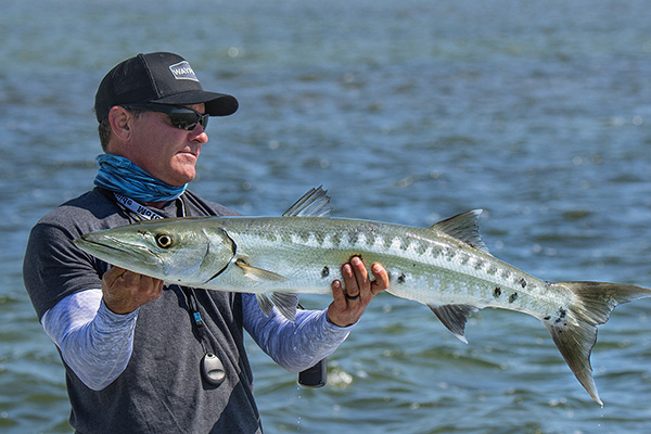 Captain Tom Rowland, co-host of Saltwater Experience holds a catch on his fishing charter in the Florida Keys.