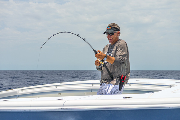 Captain Scott Walker, co-host of Into the Blue reels in a line from his fishing charter in the Florida Keys.