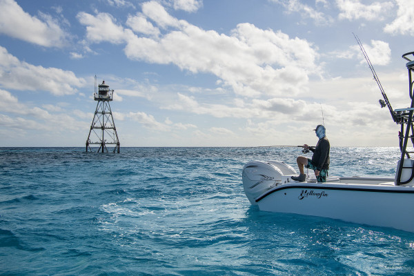 An angler is deep sea fishing in the Florida Keys from his fishing charter.